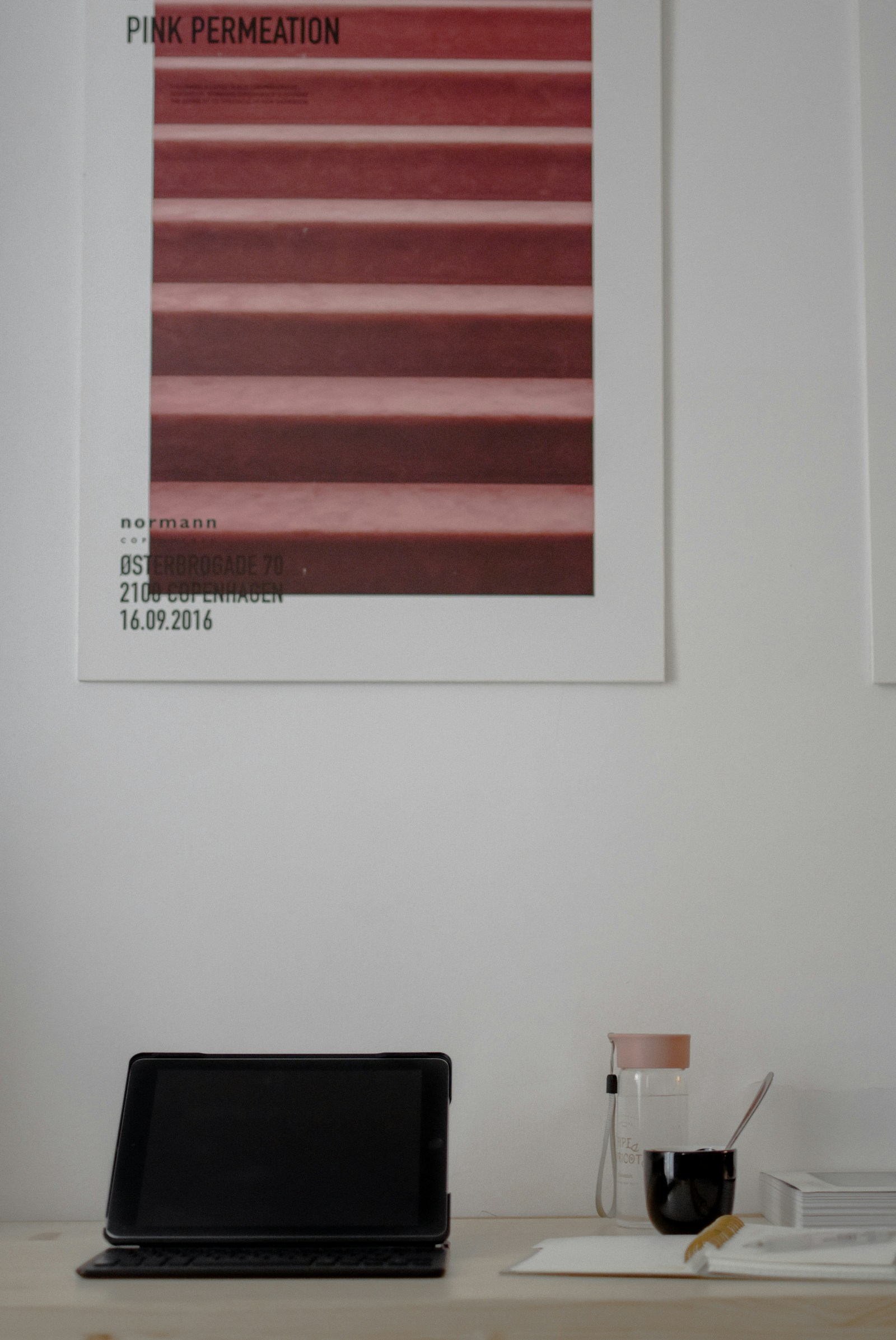A desk with a notebook, coffee, and a laptop showing a portfolio dashboard