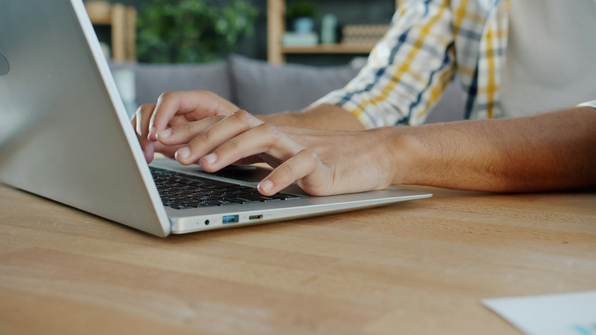A desk with a notebook, coffee, and a laptop showing a portfolio dashboard