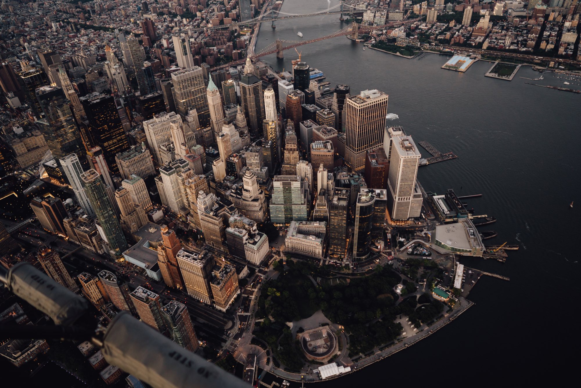A city financial district skyline at dusk with lit office towers